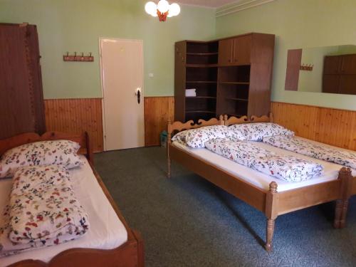 a bedroom with two beds in a room at Triniti Vendégház in Eger