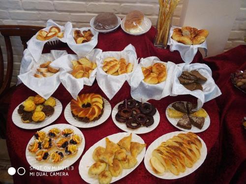 a table with plates of different types of pastries at Hotel BEK in Tashkent