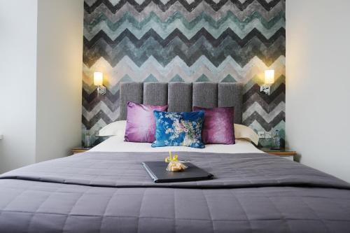 a bedroom with a bed with a tray on it at The Cleveland in Torquay