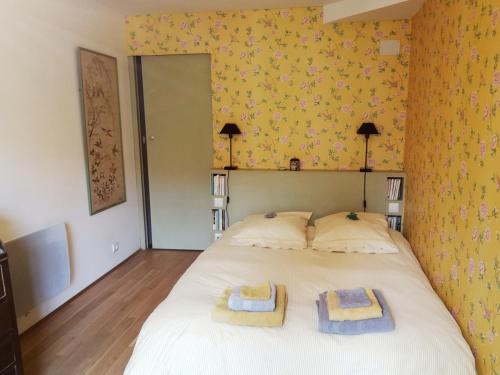 een slaapkamer met een bed met twee handdoeken erop bij La Forge in Arcis-le-Ponsart
