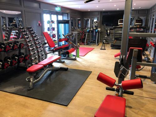 a gym with a bunch of equipment in it at Villiers Hotel in Buckingham