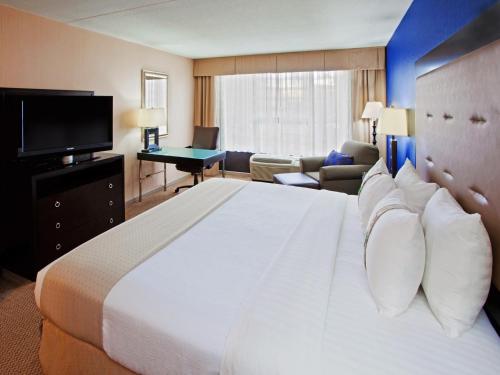 a hotel room with a large bed and a television at Holiday Inn Washington D.C. - Greenbelt Maryland, an IHG Hotel in Greenbelt