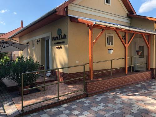 a front porch of a house with a railing at Park-Lak Vendégház in Makó