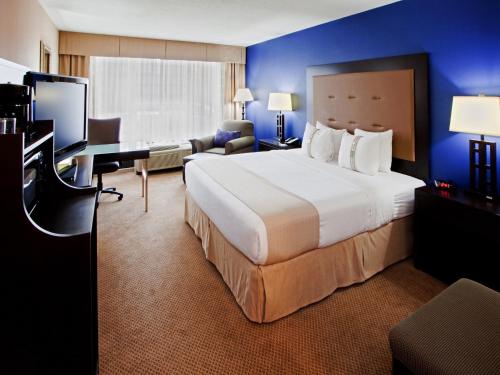 a hotel room with a large bed and a desk at Holiday Inn Washington D.C. - Greenbelt Maryland by IHG in Greenbelt