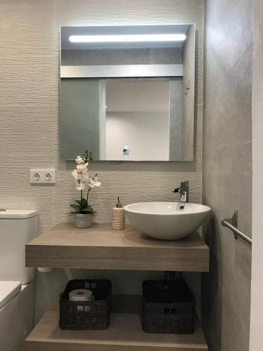 a bathroom with a sink and a mirror at Casa Cumbre del Sol in Benitachell