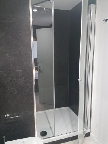 a shower with a glass door in a bathroom at Archinuè in Siracusa