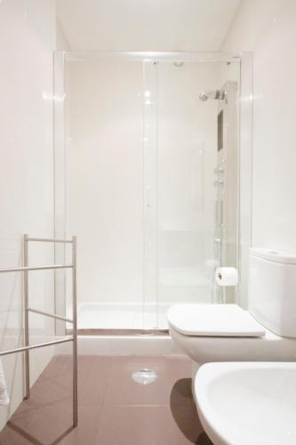 a bathroom with a shower and a toilet and a sink at OHH - Casa da Foz- Near the Beach in Porto