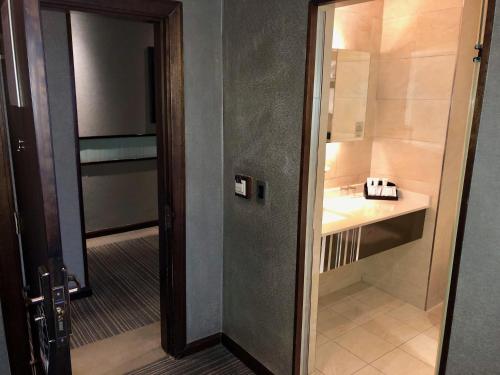 a door leading into a bathroom with a sink at Coastlands Musgrave Hotel in Durban