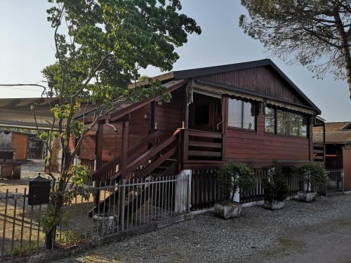 a small wooden house with a fence in front of it at Lido di Sesto in Sesto Calende