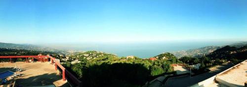an aerial view of a mountain with the ocean at Bzommar Palace Hotel in Harisa