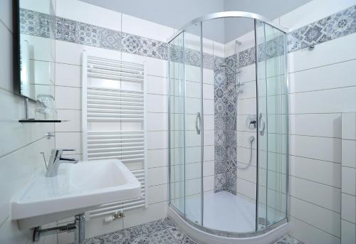 a bathroom with a shower and a sink at Penzion Královské lázně in Poděbrady
