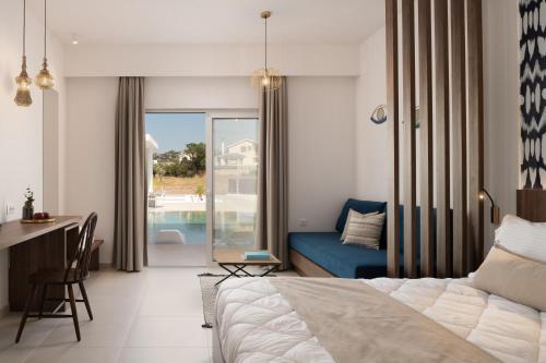 a bedroom with a bed and a desk and a couch at Nama Retreat in Pastida