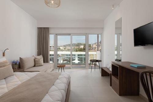 a hotel room with a bed and a living room at Nama Retreat in Pastida