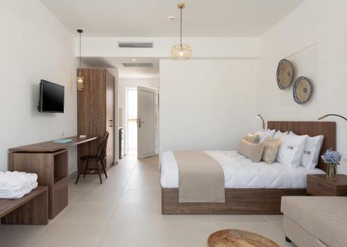 a bedroom with a bed and a desk and a couch at Nama Retreat in Pastida