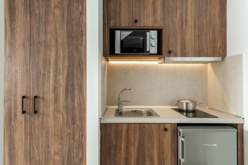 a small kitchen with a sink and a microwave at Nama Retreat in Pastida
