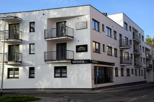 a white building with balconies on the side of it at W&K Apartments - Ginger Suite - Faktura VAT, Parking in Koszalin
