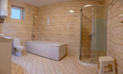 a bathroom with a shower and a tub and a toilet at Sunset Vibes in Arapya - Breathtaking Views and Pool - by Flаt Manаger in Arapya