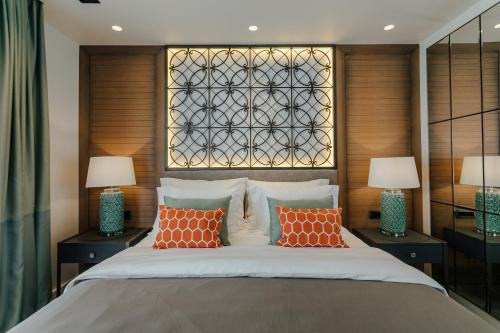 a bedroom with a large bed with orange pillows at Boutique Hotel & Spa Casa del Mare - Mediterraneo in Herceg-Novi