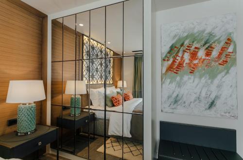 a bedroom with a bed and a glass wall at Boutique Hotel & Spa Casa del Mare - Mediterraneo in Herceg-Novi