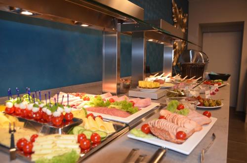 a buffet line with many different types of food at Hotel Garni Nordseejuwel in Horumersiel