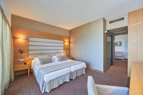 a bedroom with a large bed in a room at Hotel Playa Golf - Adults Only in Playa de Palma