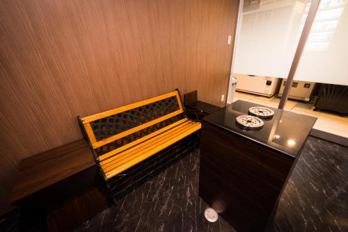 an empty room with a wooden desk and a counter at Natural Hot Spring SUPER HOTEL Kumamoto Chamber of Commerce in Kumamoto