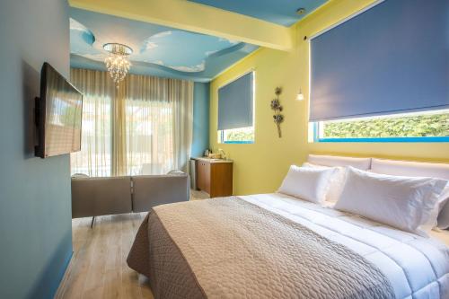 a bedroom with a bed and a large window at Haven Beach in Faliraki
