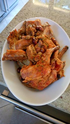 a plate of meat with beans on a counter at Chambres d'hôtes Les Iris in Sospel