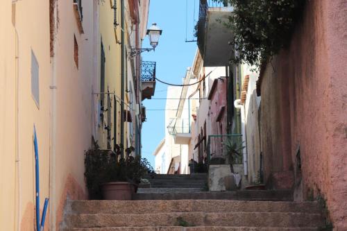 an alley with stairs in an old town at Clelia's Boutique Rooms & Suites in La Maddalena