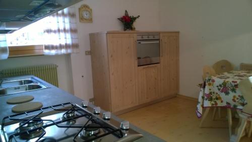 a kitchen with a stove and a counter top at Appartamento N. 7 in Livinallongo del Col di Lana