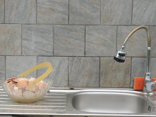 a bowl of food sitting on a counter next to a sink at Villa Platskos vol3 in Kriopigi