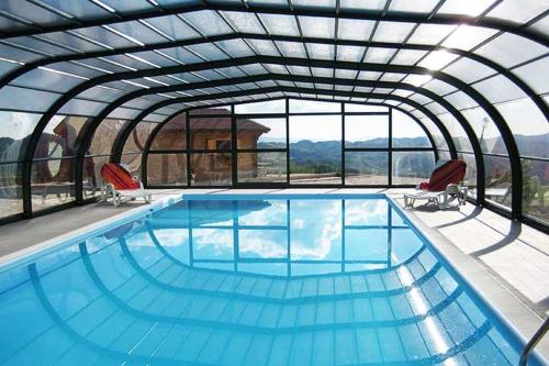 a large swimming pool with two chairs and a pool at Appartment- Betulla in Apecchio