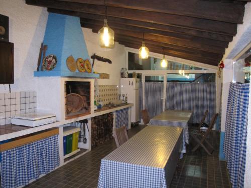 a kitchen with a counter and a table in a room at Parque de Campismo Rural Quinta das Laranjeiras in Ribeira Grande