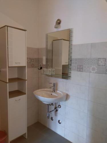 a bathroom with a sink and a mirror at Obala 111 in Poljica