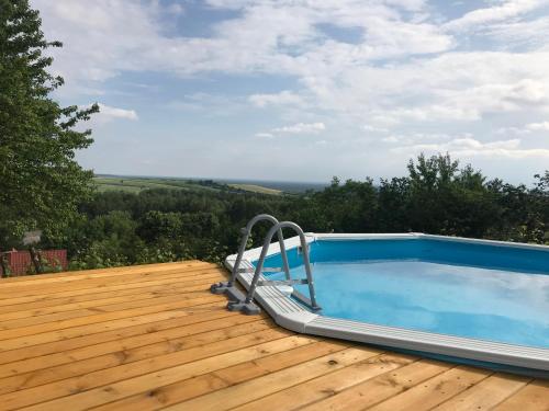 a swimming pool on top of a wooden deck at Polana in Lipowiec