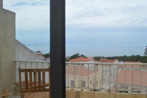 a window with a view of a building at Holidays 71 in Nazaré