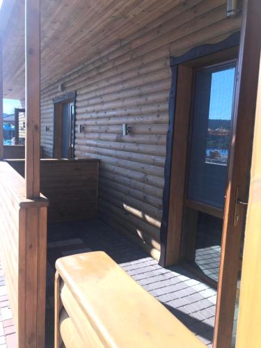 a room with a wooden wall with a window at Глухомань Аквапарк in Poltava