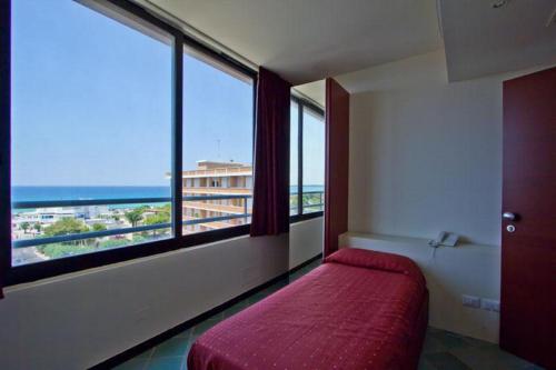 Ένα ή περισσότερα κρεβάτια σε δωμάτιο στο Hotel Baia Verde Gallipoli