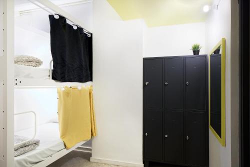 a room with a closet with black cabinets at Bed and Bike Barcelona in Barcelona
