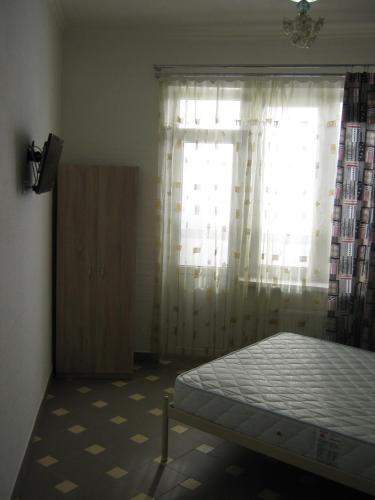 a bedroom with a bed in front of a window at Мини отель П88/1 in Odesa