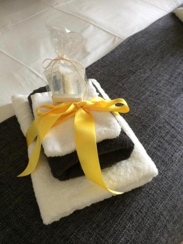 a pile of towels with a bottle on top at Villa van Brienen in Dilsen-Stokkem