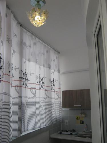 a bathroom with a shower curtain and a sink at Мини отель П88/1 in Odesa
