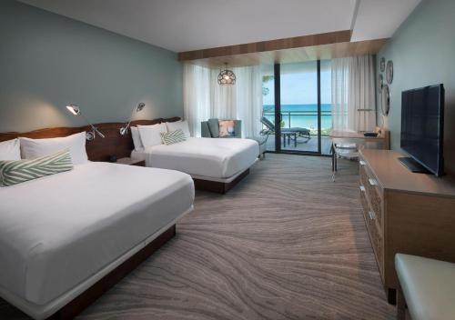 a hotel room with two beds and a television at Zota Beach Resort in Longboat Key