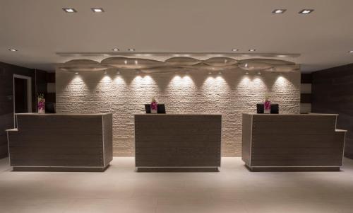 a lobby with a brick wall with lights on it at Zota Beach Resort in Longboat Key