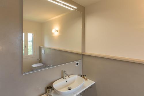 a bathroom with a sink and a large mirror at Bellavalle ROOMS Vinci Florence Tuscany in Vinci