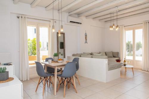 a living room with a table and chairs and a couch at Sorokos Suite 8 in Naxos Chora