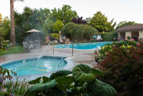 a swimming pool with a slide in a yard at El Pueblo Inn in Sonoma