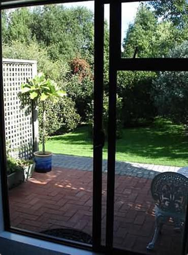 a view from a window of a patio with a chair at Warkworth Country House in Warkworth