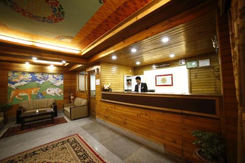 a man is standing at a bar in a building at Sikkim Tourist Centre in Pelling