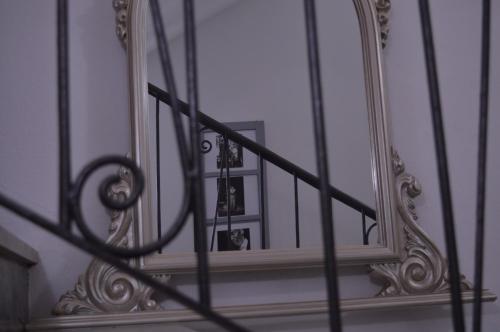 a mirror sitting on the side of a stairway at Musica Guest House in Alghero